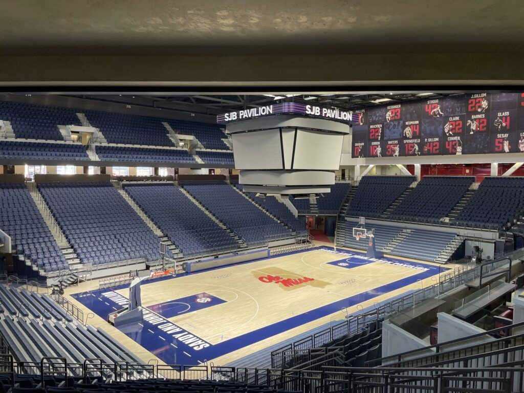 Indoor high school basketball court with hardwood floor and hoop